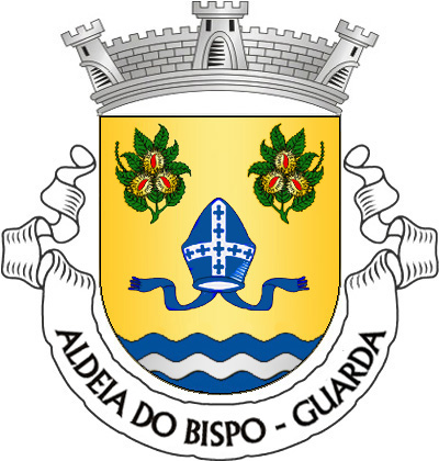 Escudo de ouro, mitra episcopal de azul com fanhões do mesmo, decorada, realçada e forrada de prata; em chefe, dois ramos de castanheiro de verde, com ouriços de ouro, abertos de vermelho; campanha diminuta ondada de azul e prata de três tiras. Coroa mural de prata de três torres. Listel branco, com a legenda a negro: «ALDEIA do BISPO - GUARDA». 