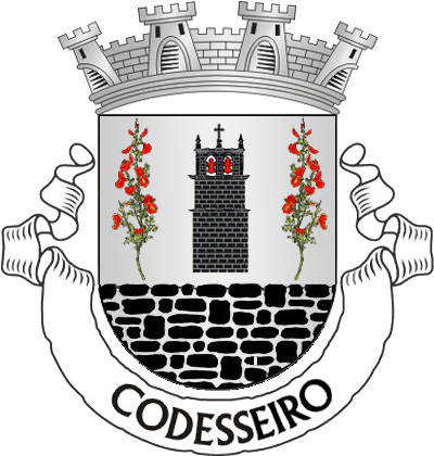 Escudo de prata, torre sineira de negro, lavrada e aberta do campo, com dois sinos de vermelho, com seus cabeçotes do mesmo, entre dois ramos de codesso de verde, floridos de vermelho, postos em pala; em campanha, pano de muralha de negro, lavrado do campo e firmado. Coroa mural de prata de quatro torres. Listel branco, com a legenda a negro: «CODESSEIRO». 