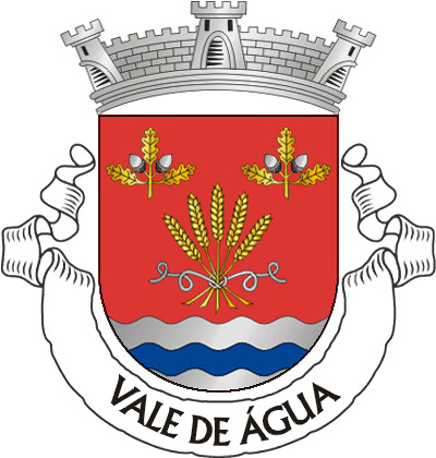 Escudo de vermelho, feixe de cinco espigas de trigo de ouro, atado por torçal de prata, entre dois ramos de sobreiro de ouro, landados de prata, alinhados em faixa, em chefe e campanha ondada de prata e azul de três tiras. Coroa mural de prata de três torres. Listel branco, com a legenda a negro: "VALE DE ÁGUA". 