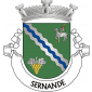 Escudo de verde, com uma banda ondada de prata, carregada de uma burela ondada de azul, acompanhada em chefe de um Agnus Dei de prata, realçado de negro, sustendo uma vara crucífera de ouro, com lábaro de prata, carregado de uma cruz firmada de vermelho e, em campanha, de um cacho de
uvas de ouro folhado de prata. Coroa mural de prata de três torres. Listel branco, com a legenda a negro: «SERNANDE».