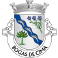 Escudo de prata, banda ondada de azul, carregada de três bogas de prata, realçadas de negro, postas no sentido da banda, acompanhada de ramo de linho de verde, florido de três flores de azul, realçadas de ouro e de um pinheiro arrancado, de verde, frutado de ouro. Coroa mural de prata de três torres. Listel branco, com a legenda a negro: «BOGAS de CIMA». 