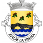 Escudo de ouro, ponte antiga de dois arcos de negro, lavrada de prata, movente dos flancos e de campanha ondada de três peças de azul e prata; em chefe, três ramos de aveleira de verde, frutados de vermelho, bem ordenados. Coroa mural de prata de três torres. Listel branco, com a legenda a negro: «AVELÃS da RIBEIRA».