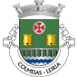 Escudo de verde, círculo de prata carregado de uma cruz da Ordem dos Templários, de vermelho e dois cortiços de ouro, realçados de negro, tudo alinhado em roquete; em campanha, ponte de sete arcos de prata, lavrada de negro, movente dos flancos e de um pé ondado de prata e azul de três tiras. Coroa mural de prata de três torres. Listel branco, com a legenda a negro: “ COLMEIAS - LEIRIA “. 