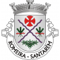 Escudo de prata, uma aspa solta de coticas de púrpura, acompanhada em chefe de uma cruz da Ordem dos Templários, de vermelho, nos flancos de dois ramos de três espigas de trigo verde, atadas de vermelho e em ponta de ramos de oliveira de verde, frutados de negro. Coroa mural de prata de três torres. Listel branco, com a legenda a negro em maiúsculas : “ ROMEIRA – SANTARÉM “.
 

