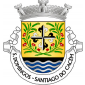 Escudo de ouro, com a cruz da Ordem de S. Domingos (cruz florenciada, gironada de negro e prata) entre dois ramos de espigas de trigo e papoilas, armadas em capela, tudo de sua cor; campanha de negro carregada de burelas ondeadas de prata e azul. Coroa mural de prata de três torres. Listel branco, com a legenda a negro, em maiúsculas: "S. DOMINGOS - SANTIAGO do CACÉM". 