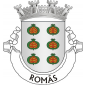 Escudo de prata, seis romãs de verde, abertas de vermelho e realçadas de ouro. Coroa mural de prata de quatro torres. Listel branco, com a legenda a negro: “ ROMÃS “. 