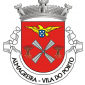 Escudo de vermelho, armação de moinho de prata, vestida do mesmo e disposta em aspa, entre duas gavelas de trigo de ouro, atadas de azul; em chefe, açor de ouro, segurando nas garras uma quina das armas nacionais. Coroa mural de prata de três torres. Listel branco com a legenda a negro, em maiúsculas : "ALMAGREIRA - VILA DO PORTO". 
