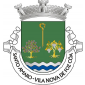 Escudo de verde, um báculo abacial de ouro, posto em pala, uma amendoeira arrancada de ouro, florida de prata e realçada de vermelho e uma parreira arrancada, folhada e gavinhada de ouro e frutada de prata, tudo alinhado em roquete; campanha diminuta de três burelas ondadas de prata e azul. Coroa mural de prata de três torres. Listel branco, com a legenda a negro: "SANTO AMARO - VILA NOVA de FOZ CÔA". 